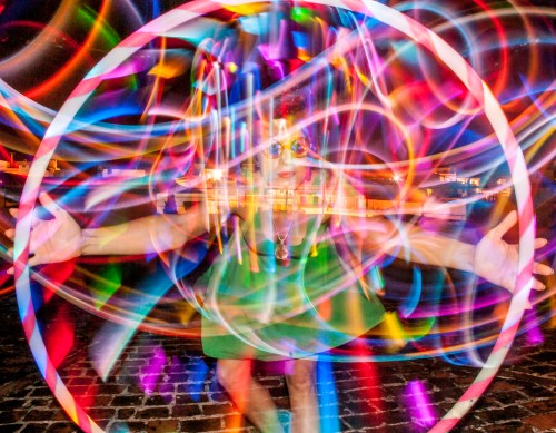 Led Hula hoops are too much fun for photography! I like to use a similar effect when I'm shooting wedding receptions. The long trails of light add a sense of excitement and mystery to the photographs.