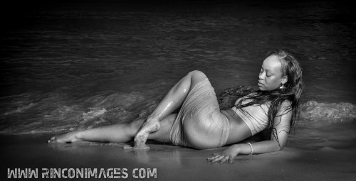 Stephanie poses for the camera by the edge of the water. 