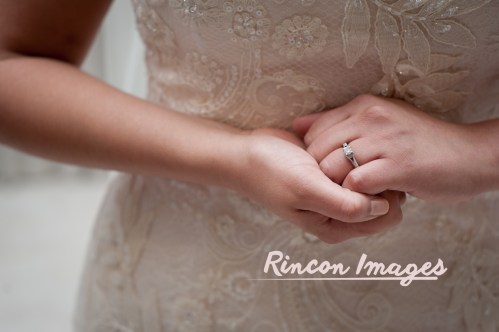 Photograph of a brides wearing a blush white dress and clasping her hands to show off her diamond wedding ring. Photography by Rincon Images photography, wedding photographer in Puerto Rico.