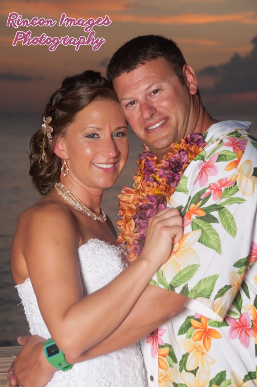 The bride and groom smiling for the camera after their destination wedding at Villa Cofresi Resort and Hotel in Rincon Puerto Rico.  Wedding photography by Rincon Images wedding photography. Wedding photographer Rincon, Puerto Rico.