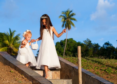 Here comes the bride! The flower girls on their way down the isle with the beautiful tropical landscape of Rincon, Puerto Rico behind them.