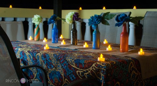 The couple decorated their table with DIY painted bottles and small led tea light candles. The look was very tropical and bohemian.