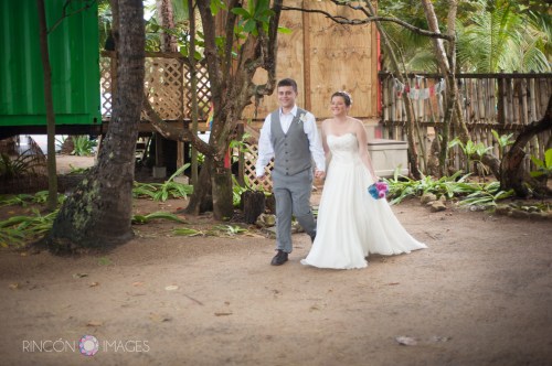 The bride and groom walking down the aisle during their wedding ceremony at the Barefoot Yoga studio in Rincon, PR.