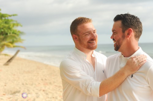 Cory and Steven on the beach in Rincon, Puerto Rico after their gay destination beach wedding in Rincon, Puerto Rico.