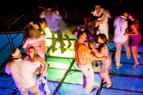 Guests having fun on the light up dance floor covering the outdoor pool just after the cake was cut.